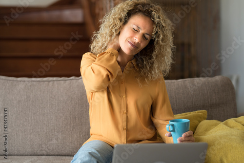 Принти на полотні Tired young woman touch stiff neck feeling hurt joint back pain rubbing massagin