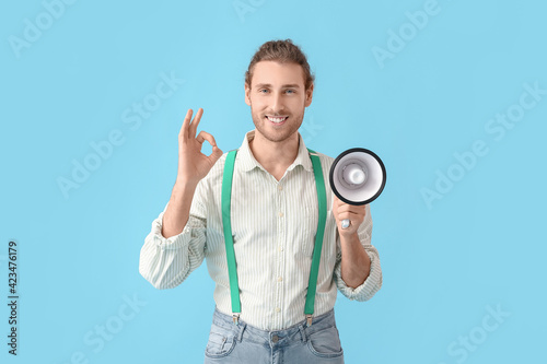 Young man with megaphone sh...