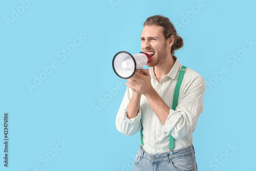 Young man with megaphone on...