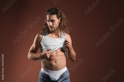Sexy young man on dark colo...