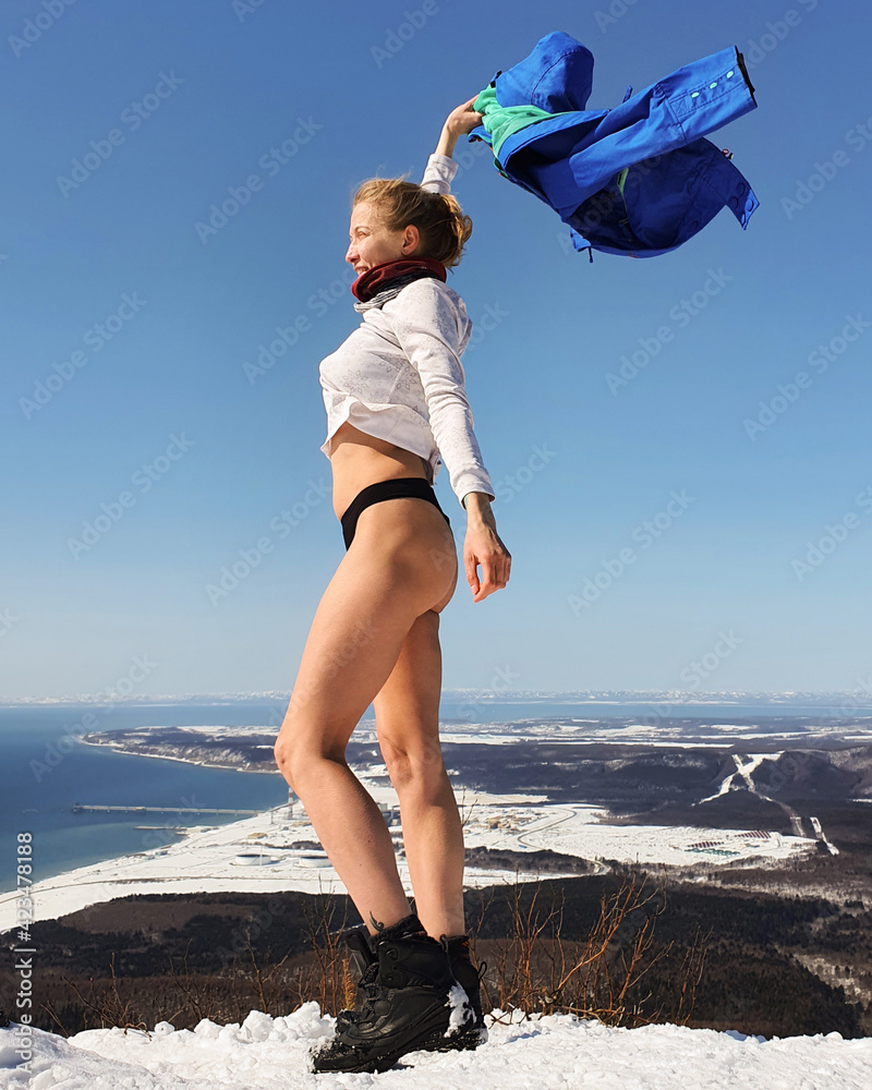 Sports girl on the top of the mountain. Trekking in the mountains in winter
