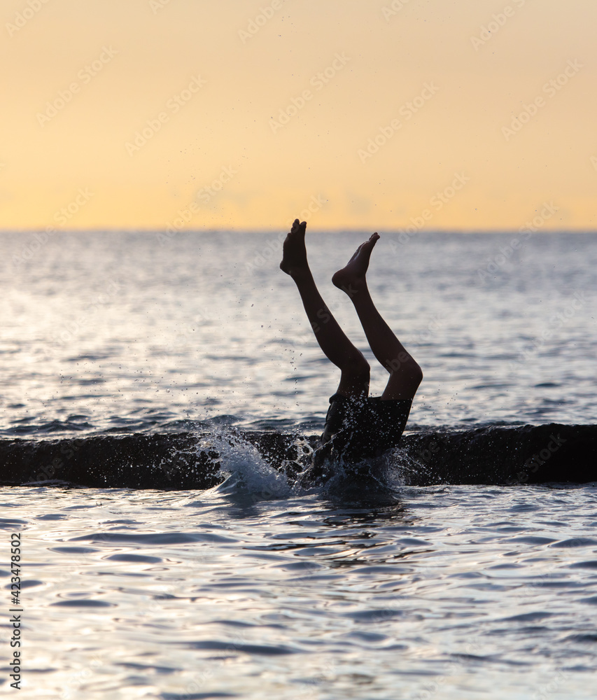Boy swims in the sea with splashes