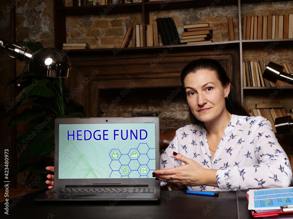 Fototapeta premium Financial concept about HEDGE FUND with sign on the laptop. A pooled investment fund that trades in relatively liquid assets and is able to make extensive use of more complex trading