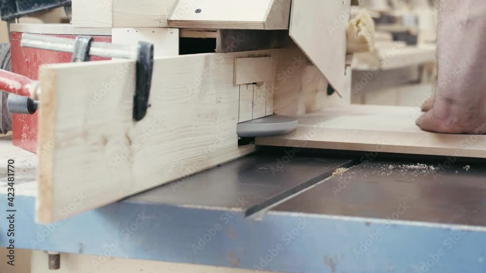 Unrecognizable carpenter makes a door panel of MDF using a router table in a professional workshop Unrecognizable carpenter makes a door panel of MDF using a router table in a professional workshop