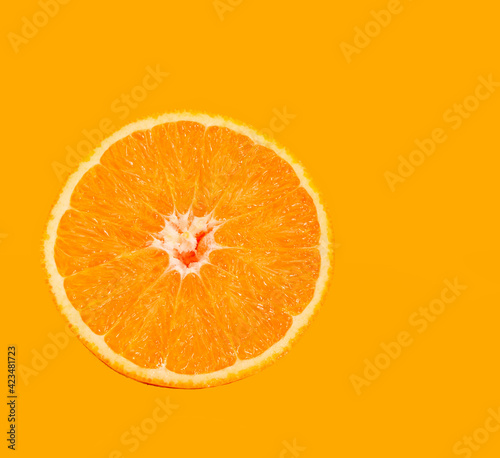 orange slice lies on a colored background