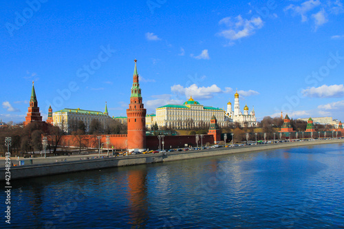 Moscow landscape with a view of the Kremlin, its Cathedral, buildings and with reflections the Moscow river, in sunny spring day.