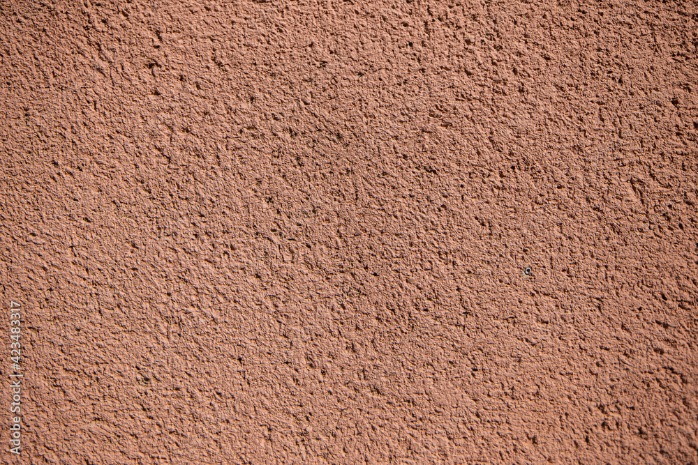 plaster texture of the outer wall of the building, teracotta red texture wall for backgrounds and copy space plaster texture of the outer wall of the building, teracotta red texture wall for backgrounds and copy space