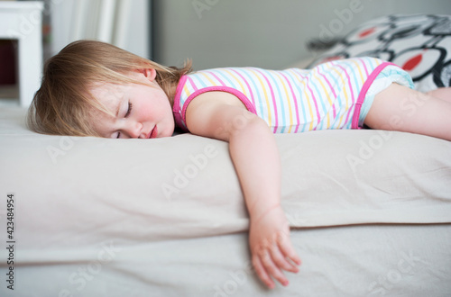 Sick baby girl lying in bed