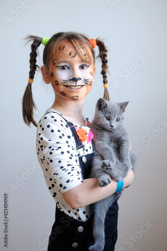 Sweet portrait of a cute little girl with a cat