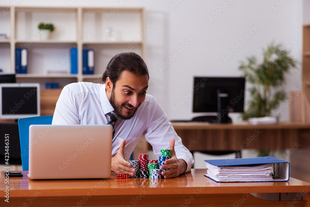 Young male employee in gambling concept Young male employee in gambling concept