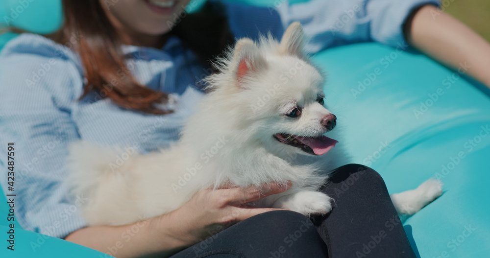 White pomeranian with pet owner at outdoor White pomeranian with pet owner at outdoor