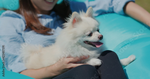 White pomeranian with pet owner at outdoor