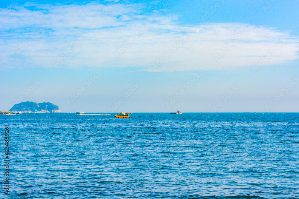 Wide blue sea seen from the middle of the ocean with fishing boat