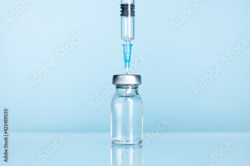 Close-up of syringe and injection vial.