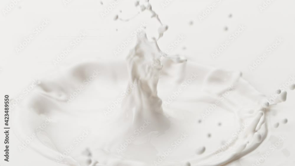 Super Slow Motion Detail Shot of Fresh Milk Crown on Blue Gradient Background at 1000 fps. Super Slow Motion Detail Shot of Fresh Milk Crown on Blue Gradient Background at 1000 fps.