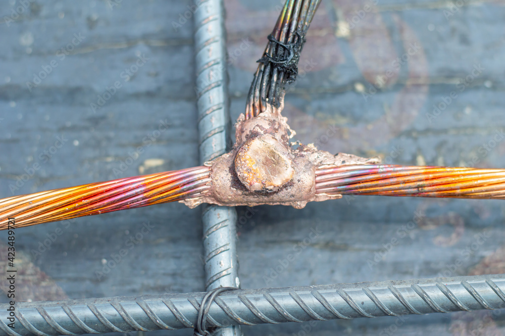 Welding copper ground wire on ground rod.Welding copper ground wire