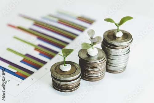 Saving money as a concept. Vintage retro stack of gold coins on the wooden background to represent It's time to do investing for retirement planning.