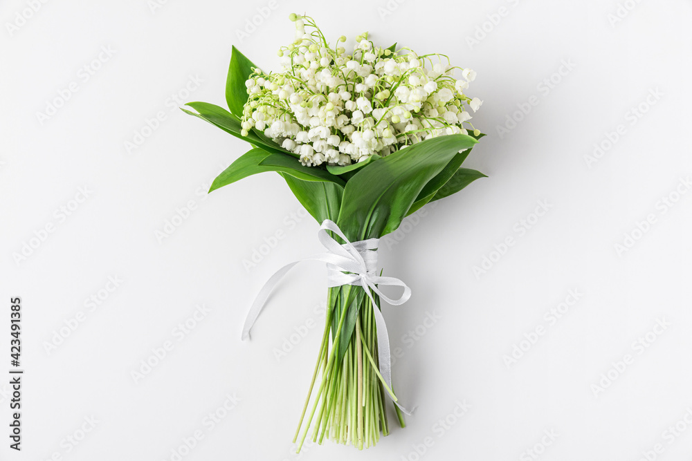 Spring lily of the valley flowers bouquet on white background. Flat lay. Top view. wedding concept Spring lily of the valley flowers bouquet on white background. Flat lay. Top view. wedding concept