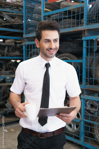 Caucasian business manager stand, smile and happy working in factory-warehouse photo