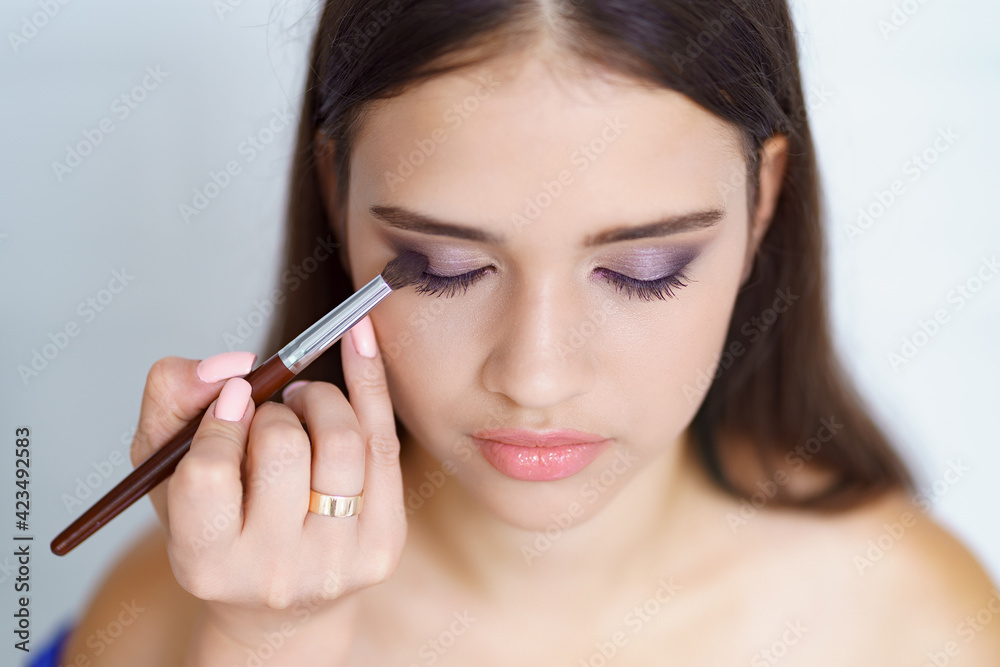Professional makeup artist working with client in dressing room Professional makeup artist working with client in dressing room