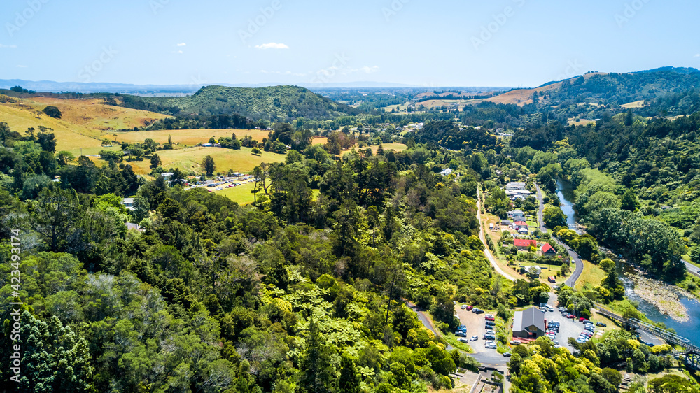 Obraz premium The road running across a mountain river in a beautiful little valley. Coromandel, New Zealand.