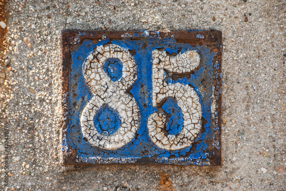 Old retro weathered cast iron plate with number 85 closeup Old retro weathered cast iron plate with number 85 closeup