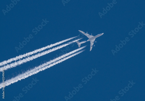 jet plane with a white plume on a blue sky