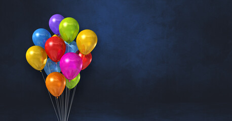 Colorful balloons bunch on a black wall background. Horizontal banner.