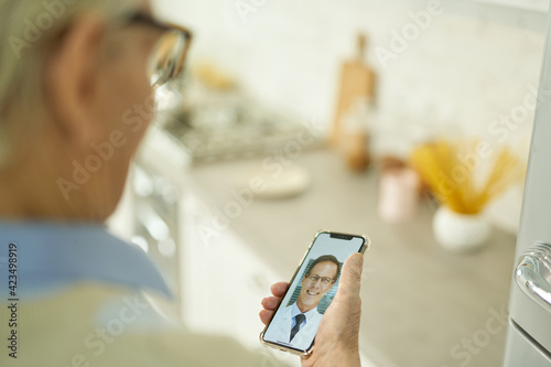 Elderly grandpa consulting his therapist on the video-call