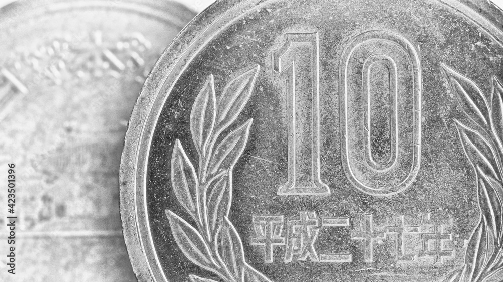 Fototapeta premium Translation: Japan 2015. Japanese coins of 10 yen on both sides close-up. Light black and white background or wallpaper. Gray backdrop about money, economy, finance, taxes and banking. Macro