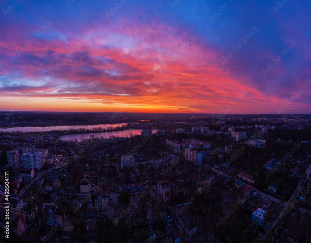 Aerial view of dramatic sunset sky above the city at dusk.