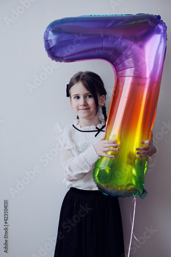 Cute little girl wiht happy birthday ballon