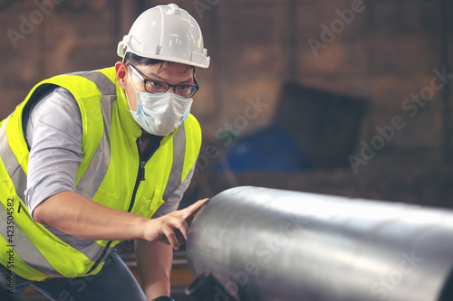 Engineers examine new coated pipe in factory, Ventory Check photo