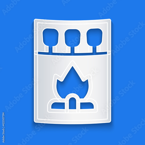 Paper cut Open matchbox and matches icon isolated on blue background. Paper art style. Vector