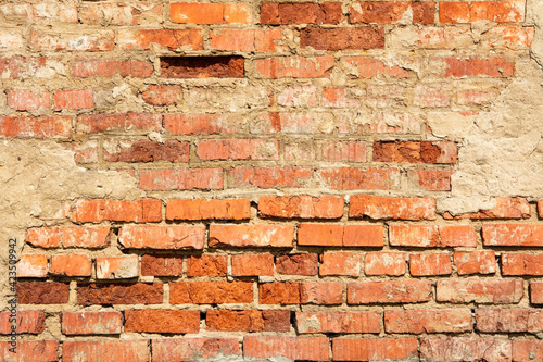 An old crumbling red brick wall