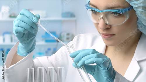 Young female tech or scientist performs protein assay photo