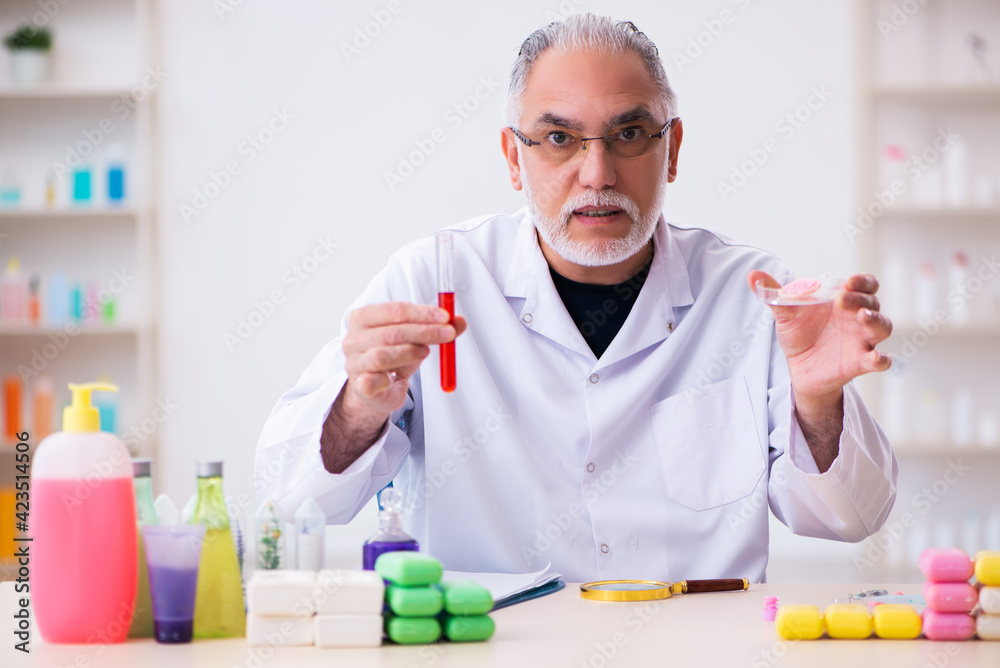 Old male chemist testing soap in the lab Old male chemist testing soap in the lab