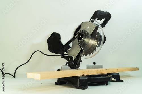 Electric circular metal saw for cutting wood on white background. photo