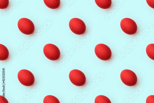 Red easter eggs seamless pattern on pastel blue background. Happy easter minimal food concept