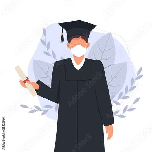 Graduated man in graduation gown and medical face mask. Class of 2021. Covid-19 prevention and new normal concept. College students wearing face masks celebrate graduation