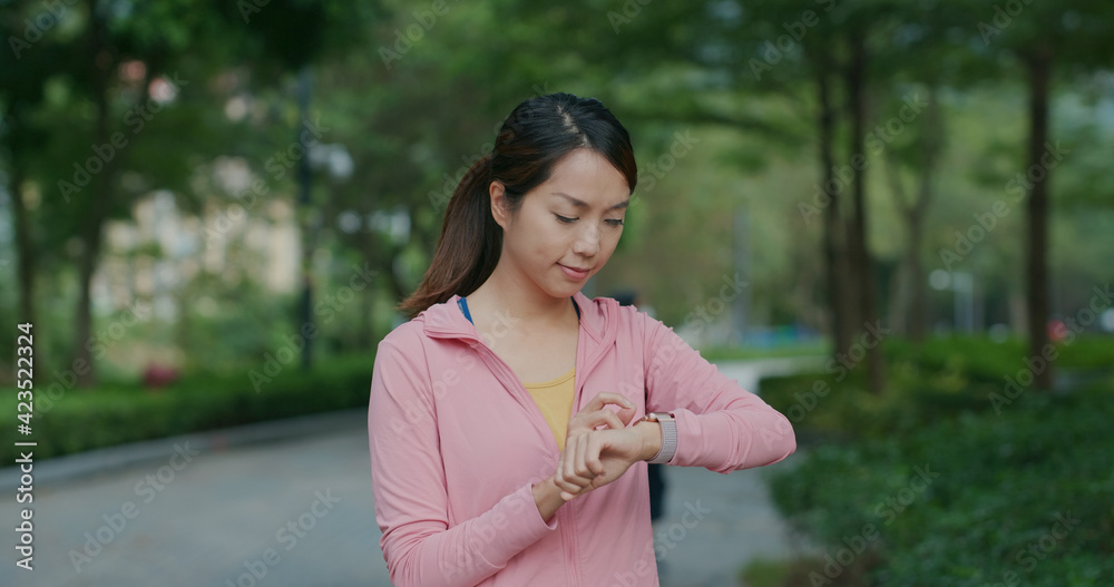 Woman use of smart watch at park Woman use of smart watch at park