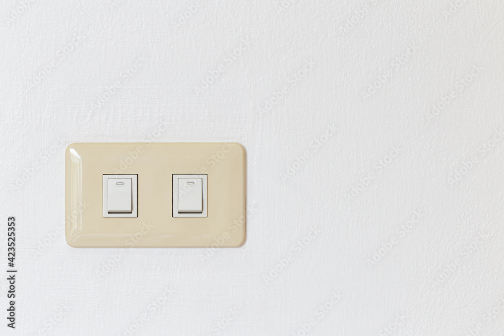 Lighting switch on white concrete background with copy space Lighting switch on white concrete background with copy space