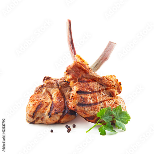 Fototapeta Grilled veal meat ribs cutlets with ingredients isolated on white background