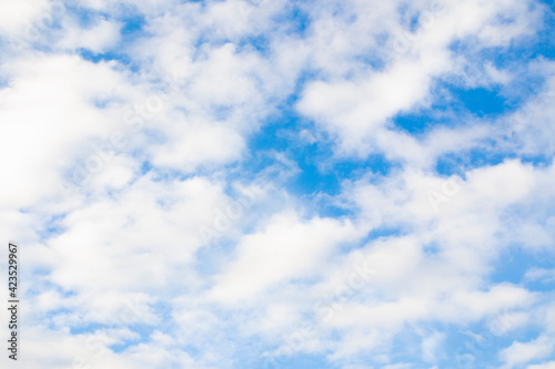 Blurred background. Blue sky and white fluffy clouds.