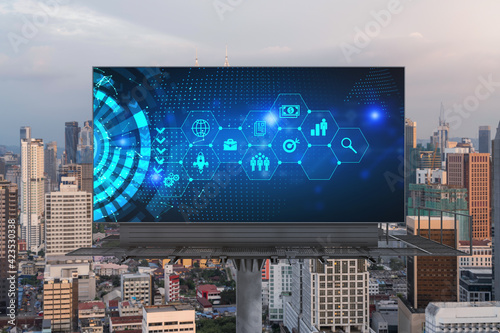 Hologram of Research and Development glowing icons on billboard. Sunset panoramic city view of Kuala Lumpur. Concept of innovative technologies to create new services and products in Malaysia, Asia.