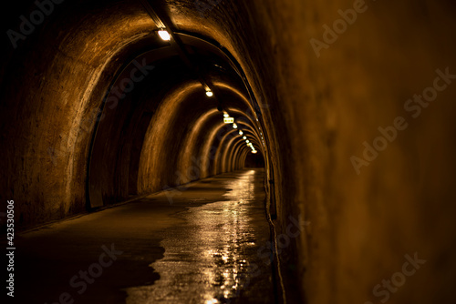 Historic underground tunnel under Zagreb historic town, capital of Croatia.Underground tunnel with several exits illuminated by light. Old tunnel in the capital of Croatia in the city of Zagreb. photo