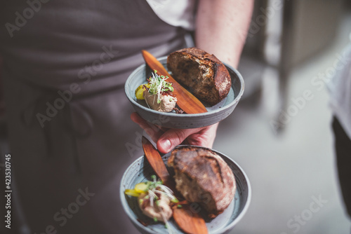 Person holding plates with food