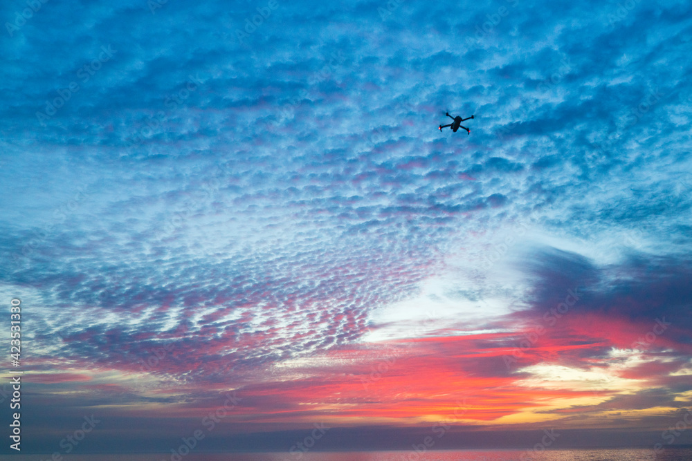 Fototapeta premium Drone in the sky at sunrise over the Atlantic Ocean