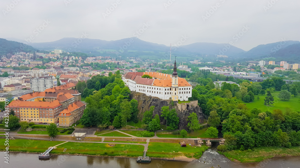 View of the medieval castle of Decin, towering over the city on a cliff. Czech Republic