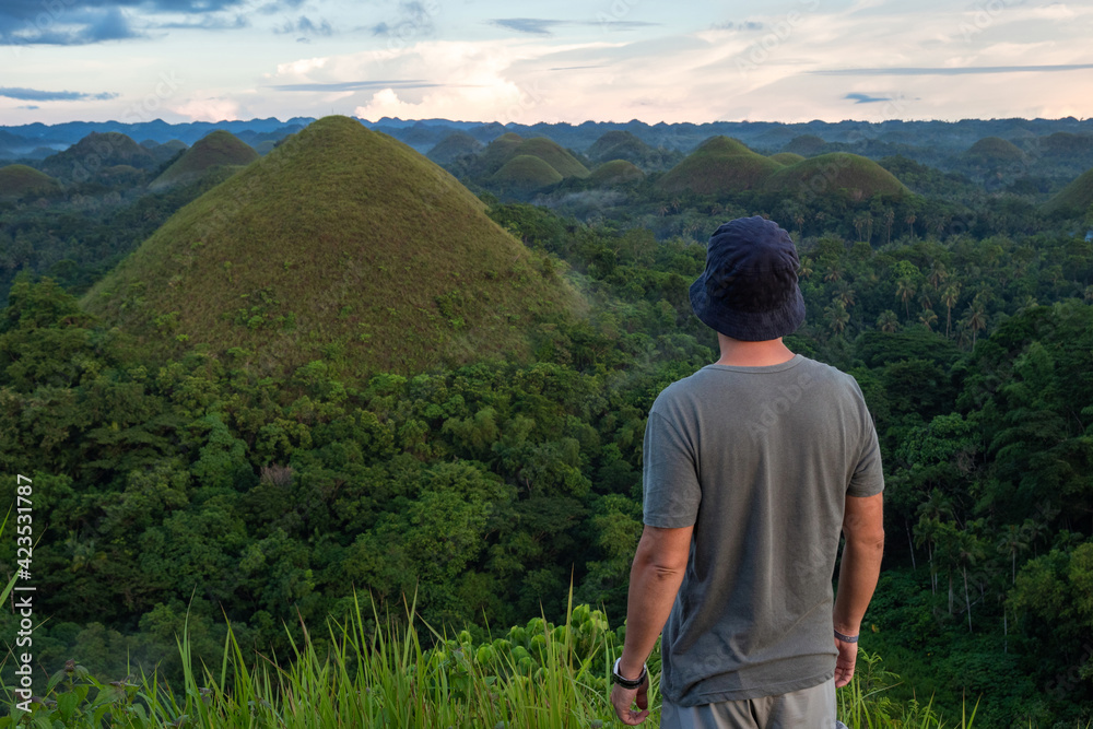 Traveler looking at view at natural landmark Chocolate Hills in Bohol Island, Philippines. 